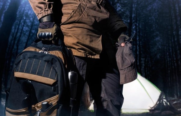 tactical-gear-man-in-tactical-uniform-holding-backpack